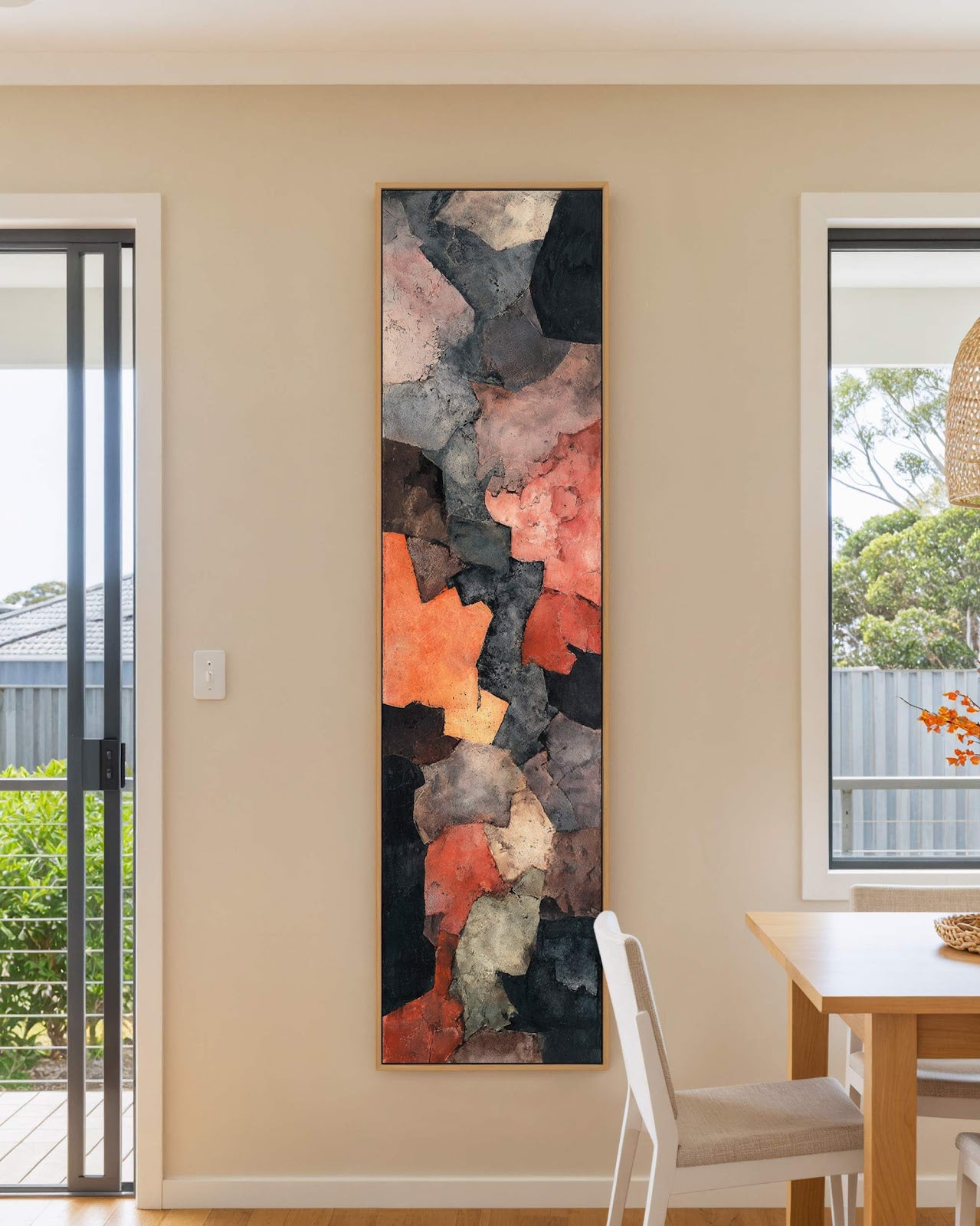 Vertical canvas wall art in interior setting.