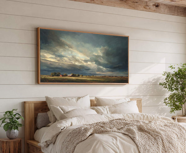 This horizontal canvas print features a dramatic, stormy sky over a rural landscape with red barns. The artwork, with its moody palette and painterly style, is displayed in a natural.