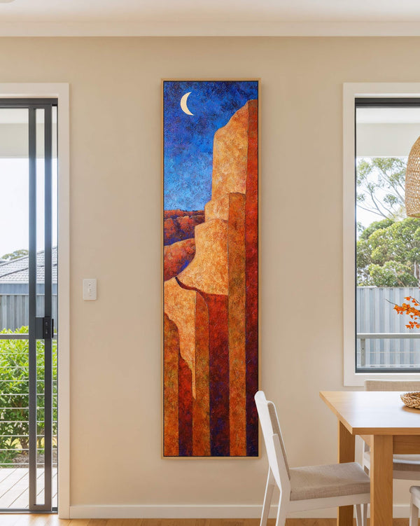 Vertical canvas wall art in interior setting.