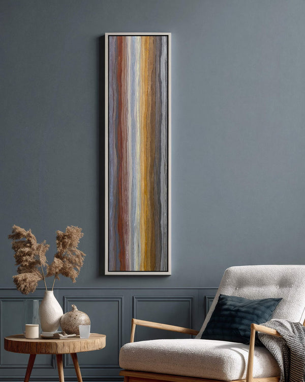 Vertical canvas wall art in interior setting.