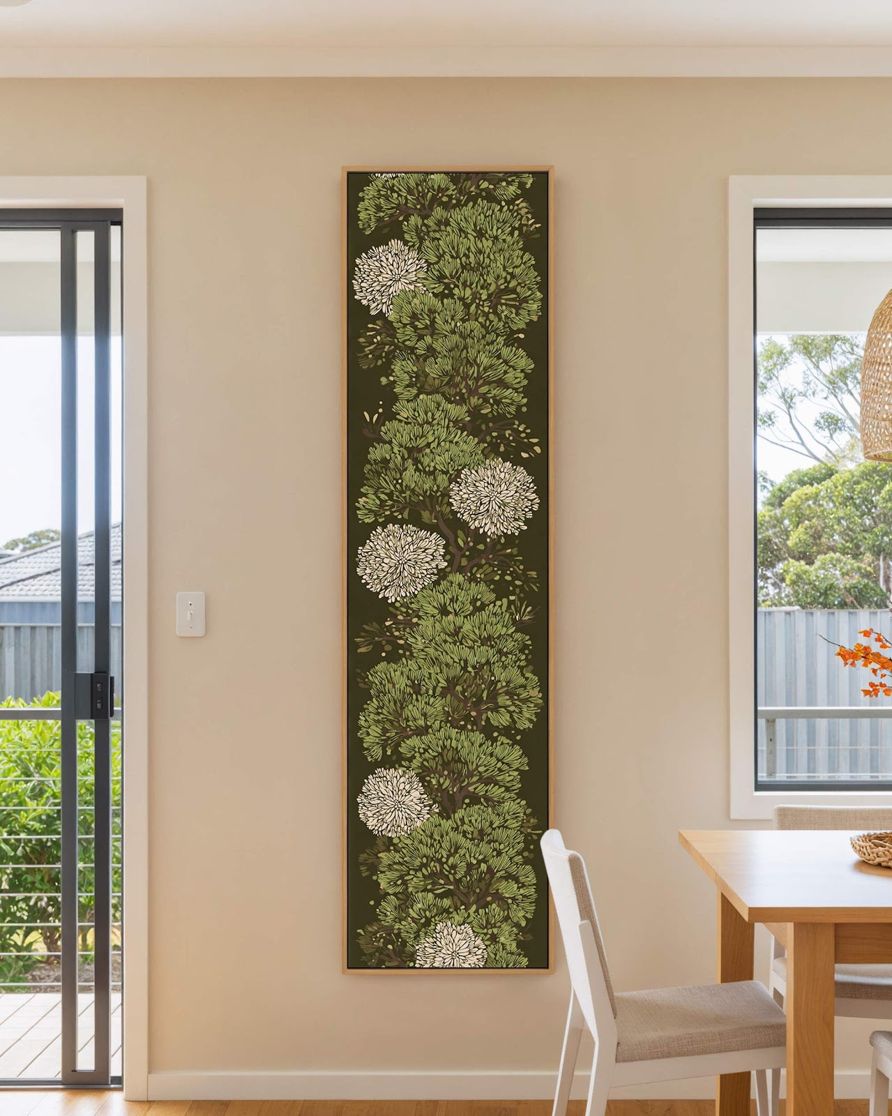 Vertical canvas wall art in interior setting.