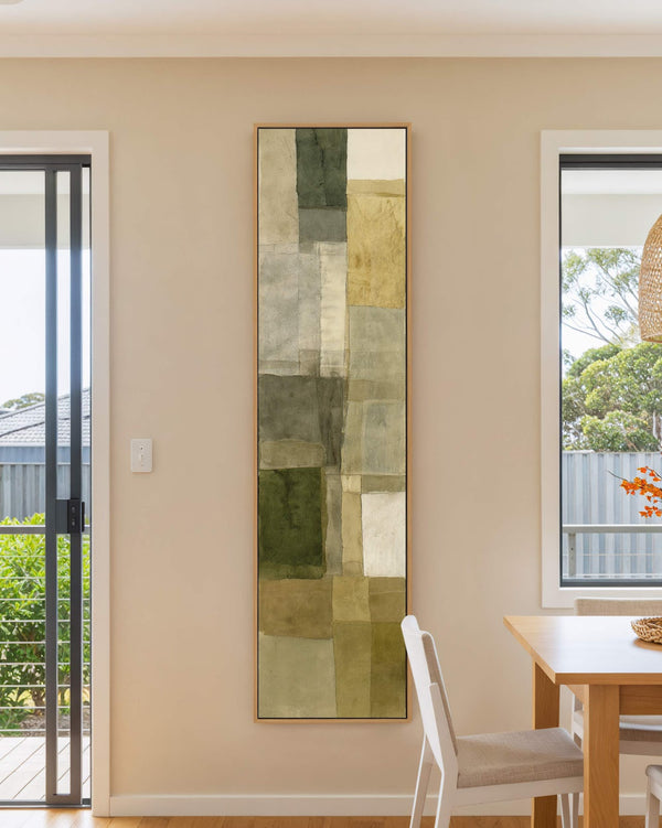 Vertical canvas wall art in interior setting.