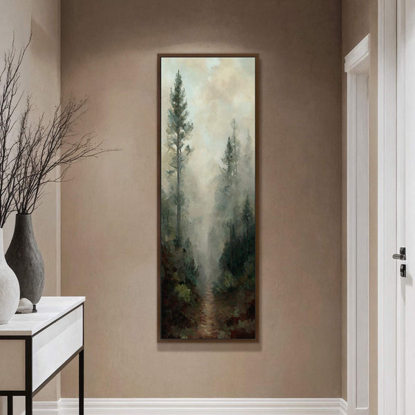 This vertical canvas wall art showcases an impressionistic forest scene with tall, dark green trees emerging from a hazy, light-toned fog, framed by a dark wood floater frame and displayed.