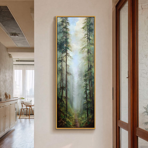 This vertical canvas wall art depicts a misty forest path with tall pine trees, rendered in a realistic style with a palette of greens and blues. It is displayed on.