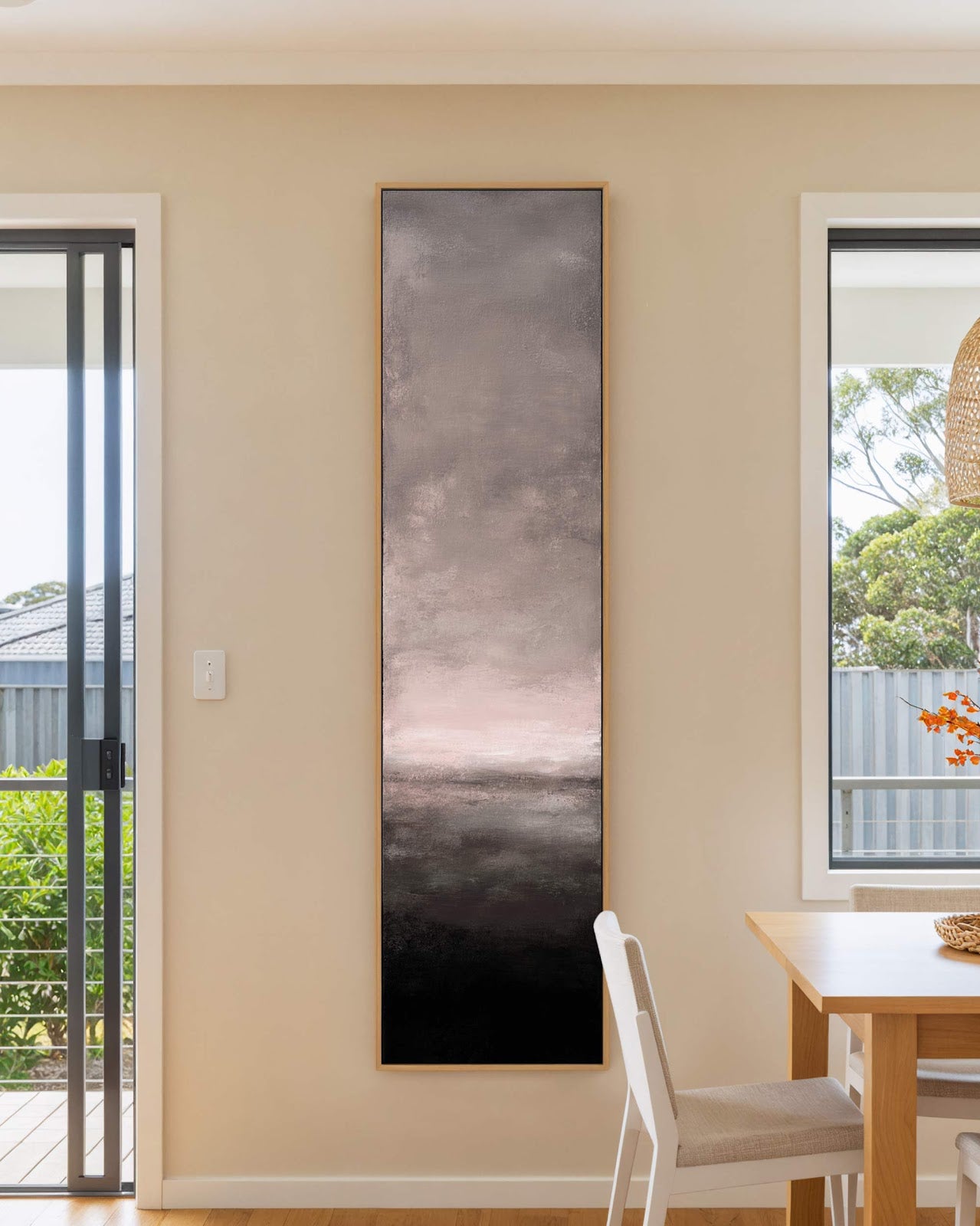 Vertical canvas wall art in interior setting.
