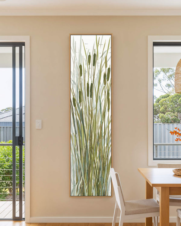 Vertical canvas wall art in interior setting.