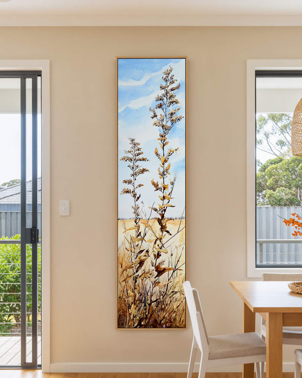 Vertical canvas wall art in interior setting.