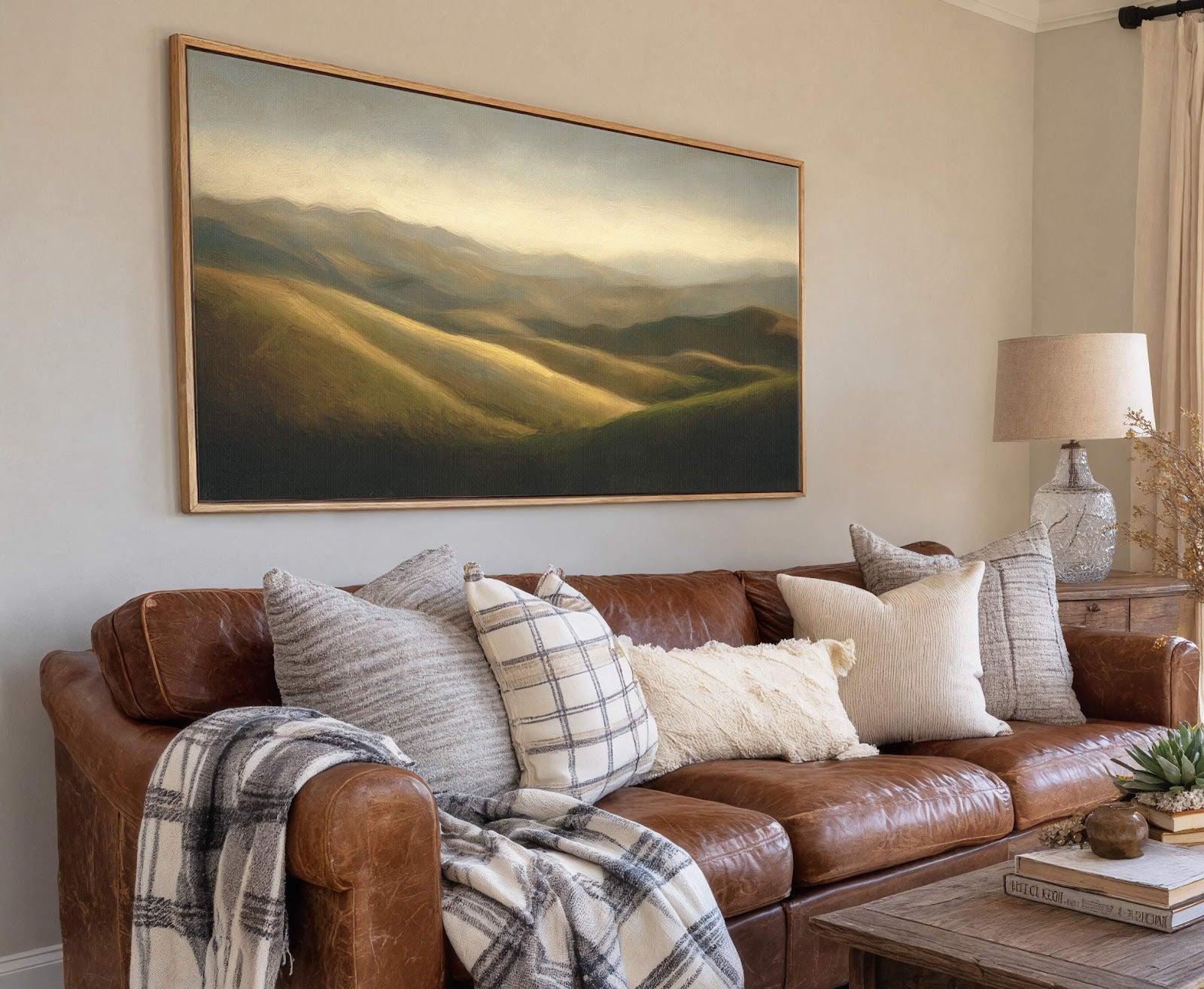 This horizontal canvas wall art features a landscape painting with rolling hills bathed in golden light, rendered in a soft, painterly style. The artwork is presented in a natural wood.