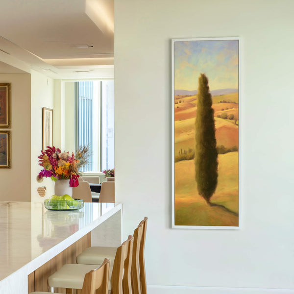 This vertical canvas print features a Tuscan landscape with a tall cypress tree, rendered in a warm, impressionistic style with a palette of greens, yellows, and oranges, displayed on a.