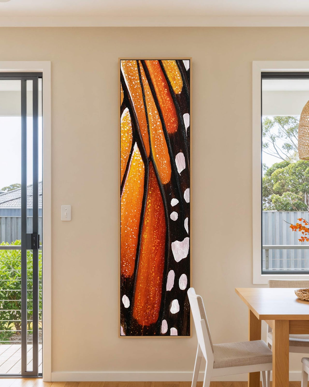 Vertical canvas wall art in interior setting.