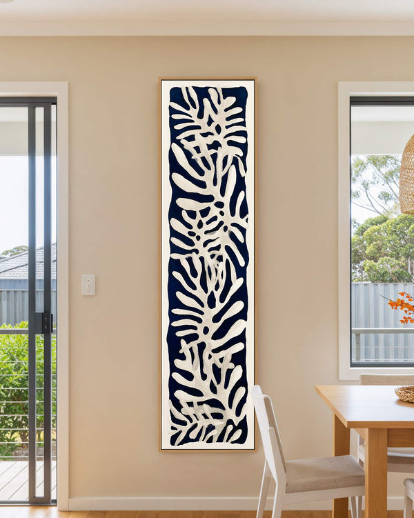 Vertical canvas wall art in interior setting.