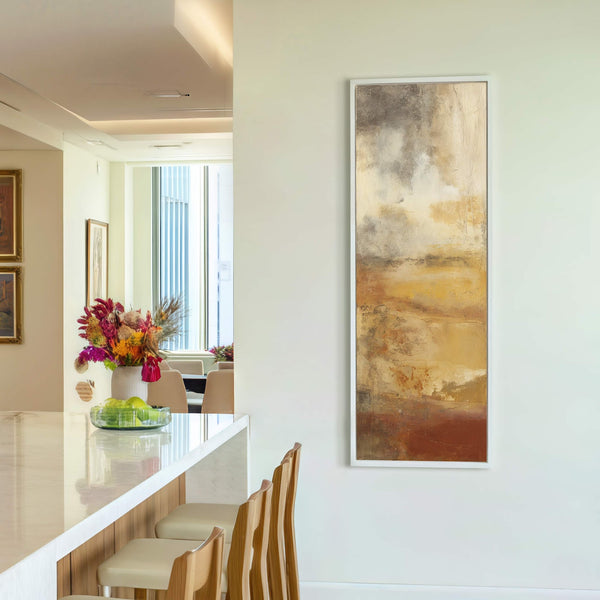 This vertical canvas wall art features an abstract expressionist style with a warm earthy palette, hanging on a plain cream wall above a white console table.