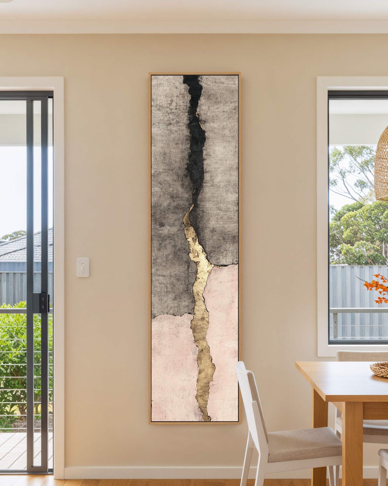 Vertical canvas wall art in interior setting.