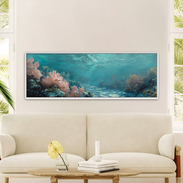 Framed underwater coral reef canvas wall art displayed above a cream sofa in a bright living room with coastal modern decor