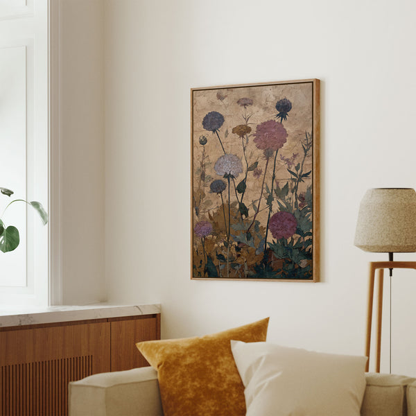 Pecan framed botanical art print featuring various purple and white thistle-like flowers and green foliage against a textured, golden, and aged background, displayed above a sofa in a bright living room