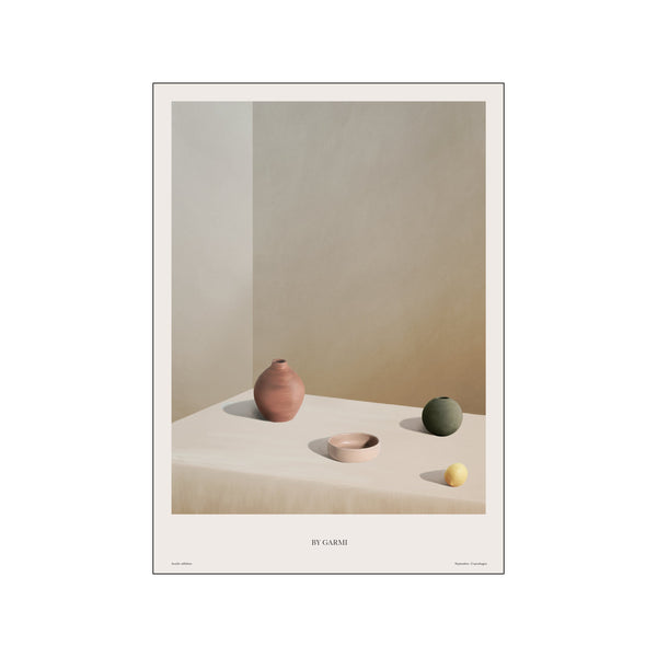 A minimalist still life featuring three ceramic vessels in terracotta, blush, and olive green, alongside a single yellow lemon, arranged on a draped surface with soft lighting.