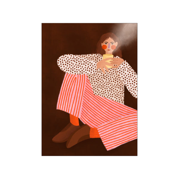 A woman with brown hair, wearing a white polka dot blouse and pink and orange striped pants, sits with a yellow cup of tea in her hands against a dark brown background.