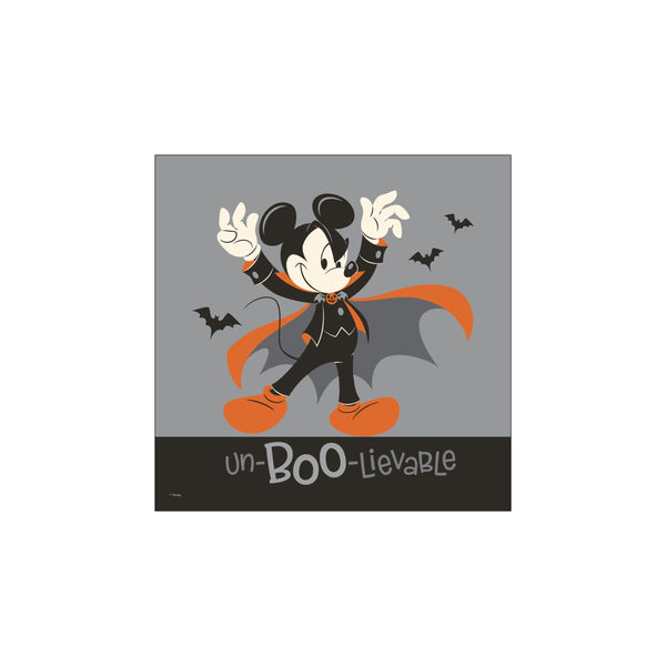 Mickey Mouse dressed as a vampire for Halloween, with a flowing orange-lined cape, striking a playful pose against a grey background with silhouetted bats and the text 'un-BOO-lievable'.
