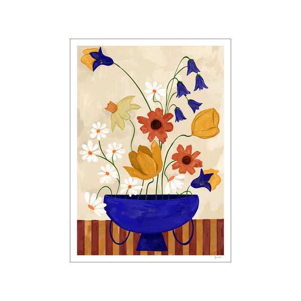 A vibrant arrangement of cheerful flowers, including daisies, daffodils, and bluebells, gathered in a bold cobalt blue vase against a textured beige background, with bold vertical stripes at the base.